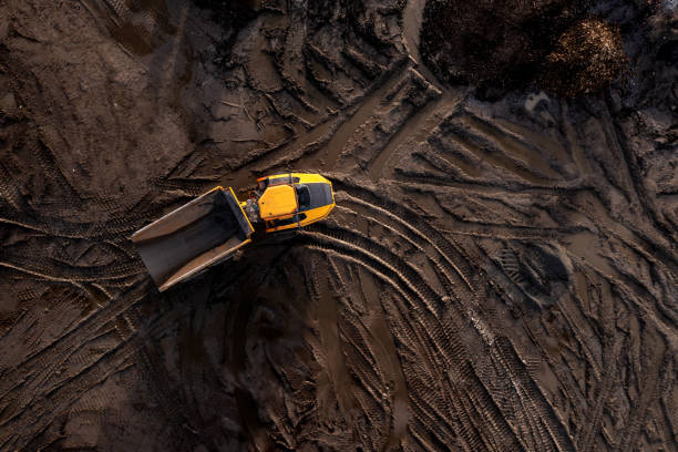 istock Aerial view above an earth mover truck on a muddy construction site 1785947565