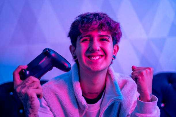 istock Portrait of a young man's face playing a video game from his PC. 1785949140