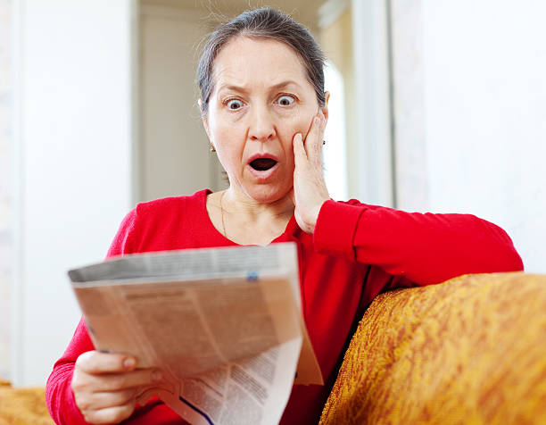 istock fright  woman with newspaper 178595088