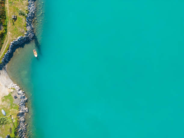 Sunny day with some clouds, reflection on the water surface, top of a mountain pass.