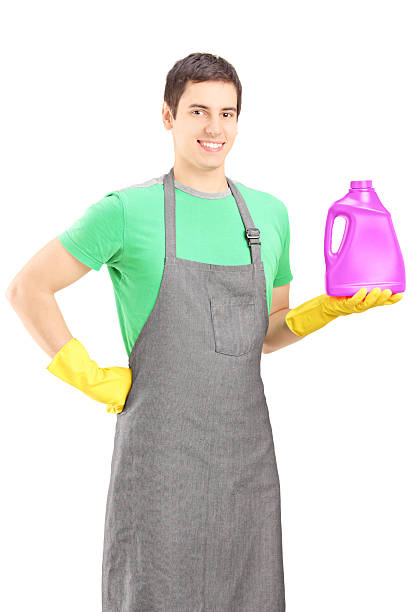 istock Young man holding a bottle of cleaning liquid 178595643