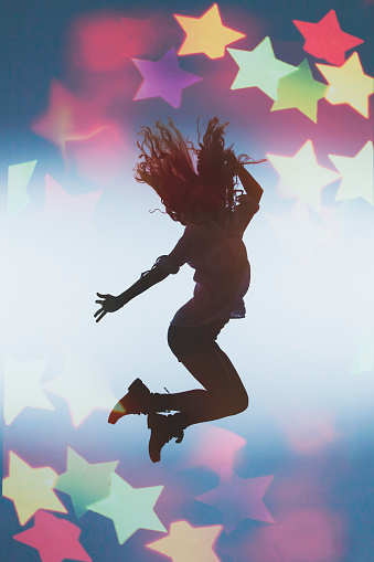 Silhouette of a dancing girl and bokeh.