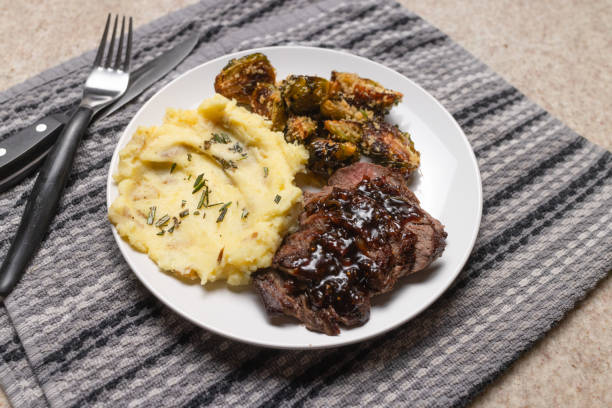 istock Glazed Beef Tenderloin with Garlic Mashed Potatoes and Rosemary Panko Brussels Sprouts - Close Up 1785960843