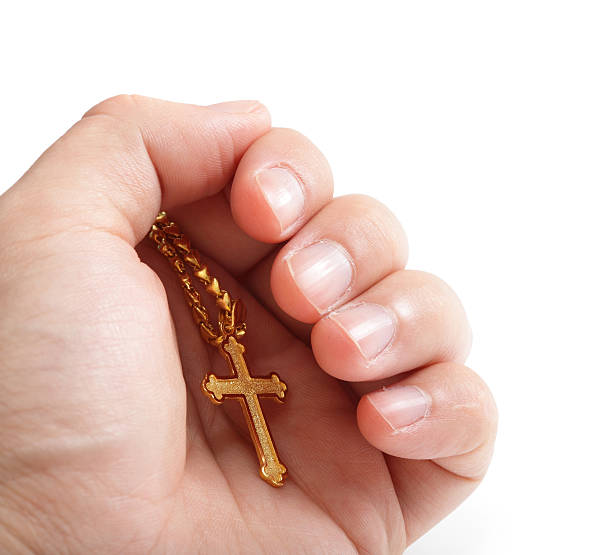 istock Hand hold golden cross necklace 178596437