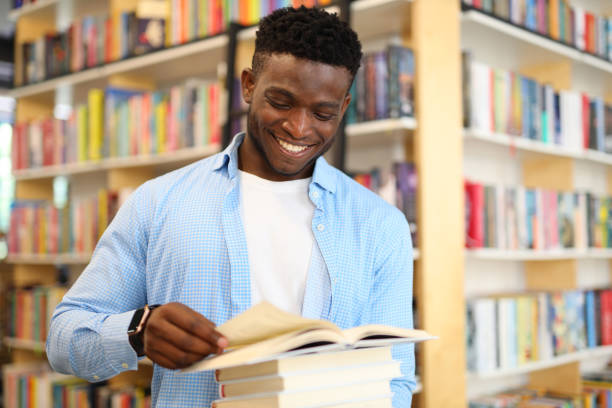 istock Joyful university student, studying in the library, radiating happiness and intelligence, surrounded by educational books. 1785968199