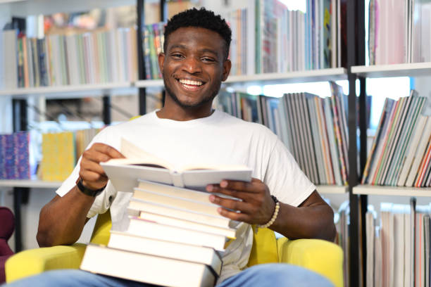 istock Cheerful student in a university library, surrounded by books, reflecting the joy of educational pursuit. 1785968268
