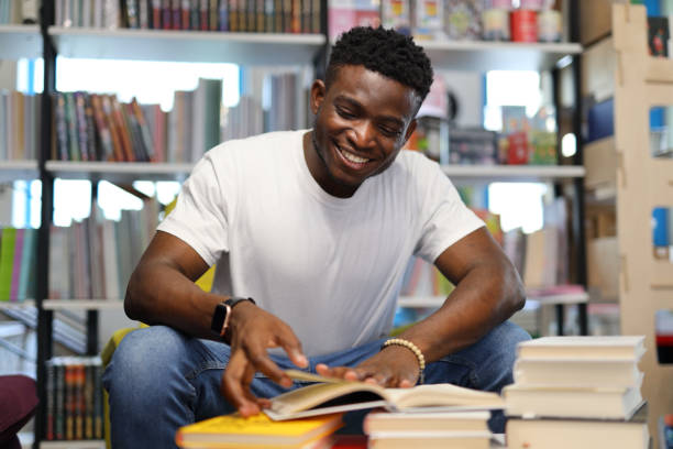 istock Focused African American student in a university library, immersed in studying amid bookshelves, showcasing academic dedication. 1785968271