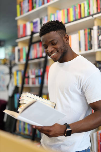 istock Young man in a university library, studying among books, representing the pursuit of knowledge and academic excellence. 1785968737