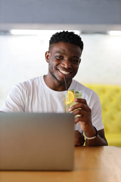 istock Happy and confident African American man in a cafe, using technology, reflecting a modern and cheerful lifestyle. 1785968836