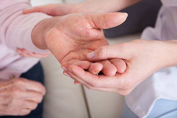 istock Young Woman Holding Senior Woman's Hand 178596991