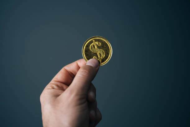 istock Hand holding golden British Pound coin 1785977162