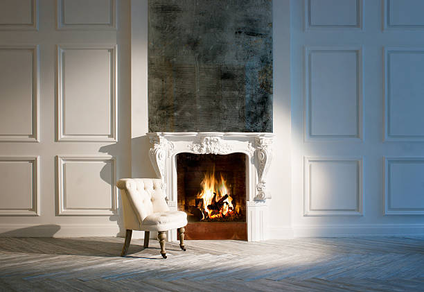 istock Small white sofa chair set by small fireplace in modern home 178598350