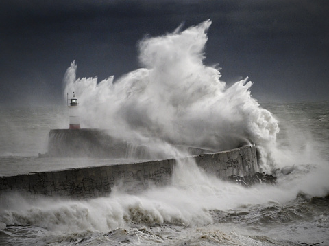 Lighthouse and harbor in a raging storm