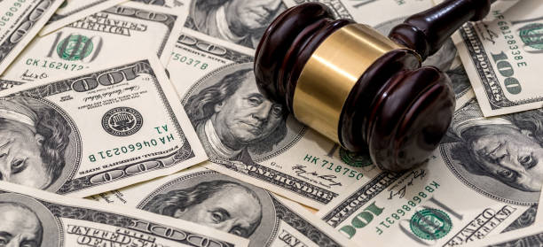 istock Judge hammer above dollar paper money background 1785993863