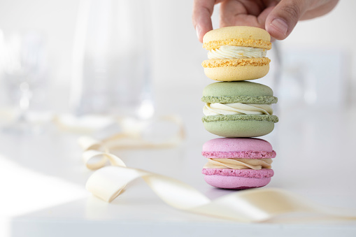 Hand holding a delicious colorful macaroons.