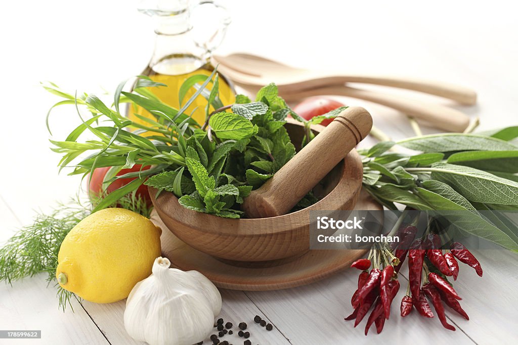 fresh herbs with mortar and pestle salad dressing ingredients Aromatherapy Stock Photo