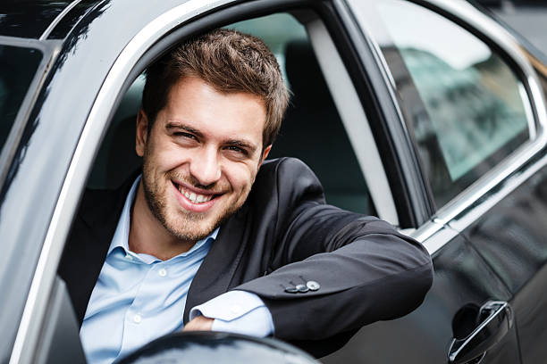 istock A smiling man in a sport coat driving a car 178599769