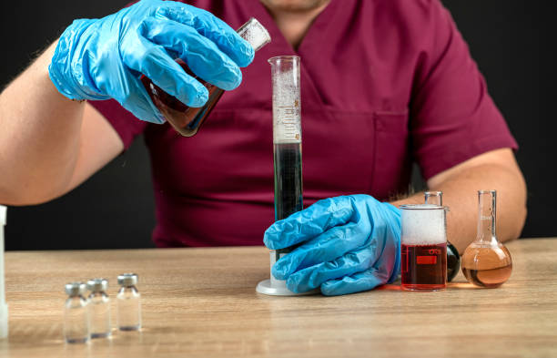 istock a man mixes a liquid in test tubes in a laboratory 1785999355