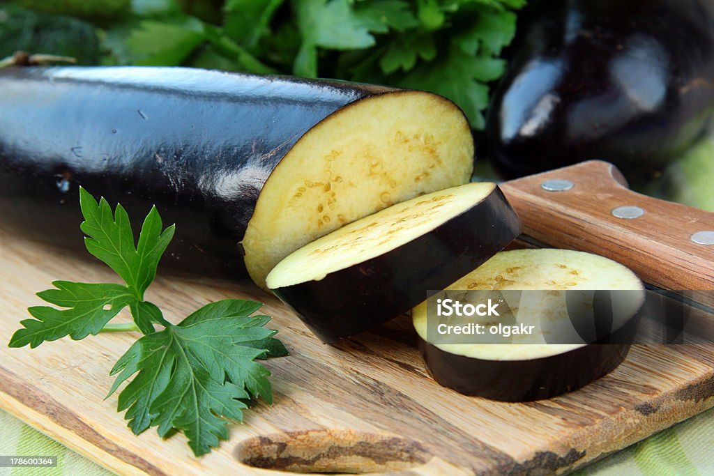ripe organic eggplants on a wooden table Eggplant Stock Photo