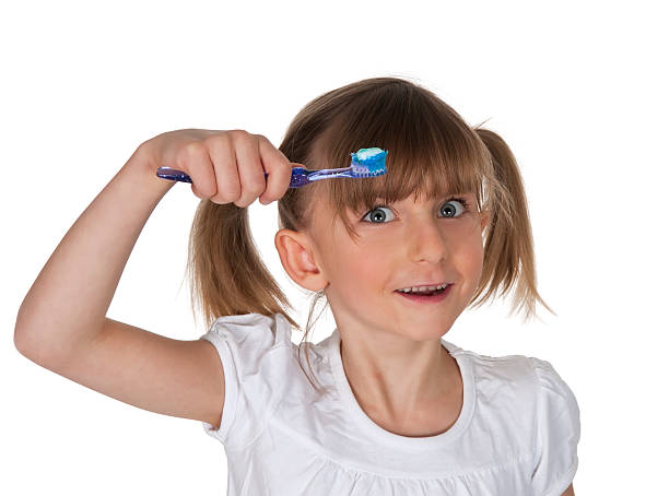 istock little girl brushing her teeth 178600692