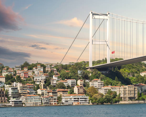 istock Traditional waterfront houses, Bosphorus bridge, and green hill with dense trees, after dawn, Istanbul, Turkey 1786011645