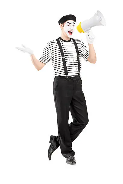 Full length portrait of a male mime artist speaking at loudspeaker and looking at camera isolated on white background