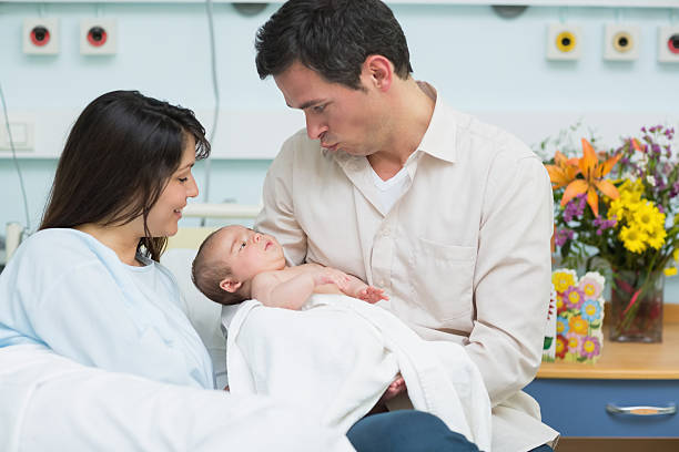 istock Mother looking at a man holding new born baby 178601864