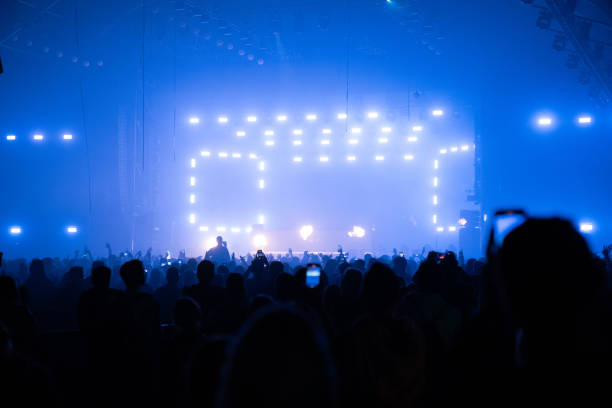 istock Light effects on performance stage. People recording with phones 1786023012