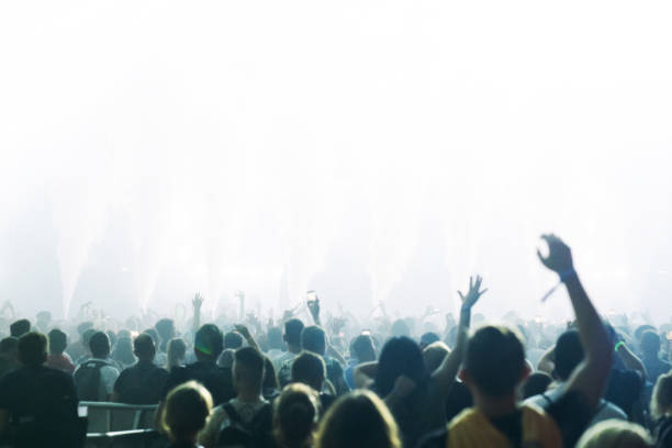 istock Crowd of people attending a concert. Bright light coming from the stage 1786023034