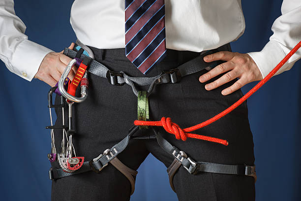 Business man in climbing harness stock photo