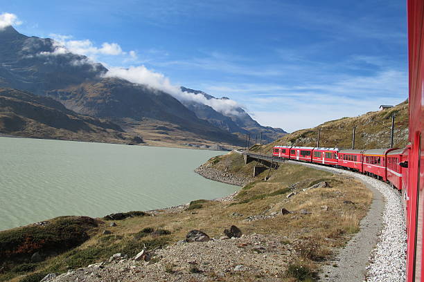 istock red train around the beautiful Swiss mountains 25 178602429