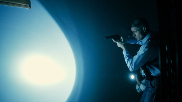 istock A male detective is aiming his gun while a female detective shines a flashlight into the darkness 1786035318