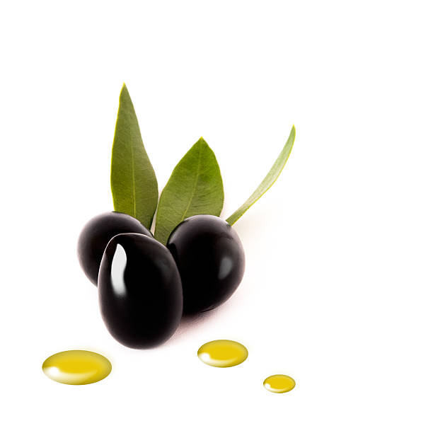 Black olives with oil drops on white stock photo