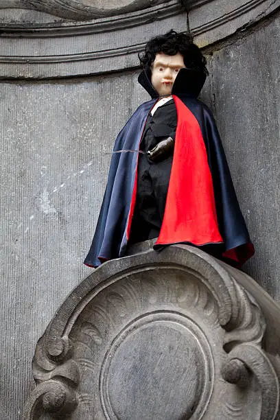 The famous Manneken Pis fountain in Brussels - dressed as a Vampire.