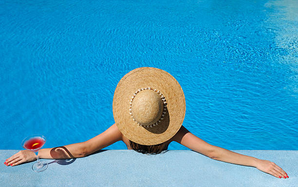 istock Woman at poolside with cosmopolitan cocktail 178605325