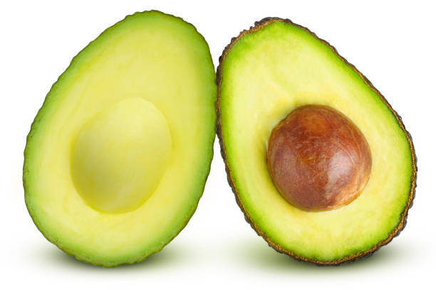 istock Cut avocados, with and without pits, facing each other, on an isolated white background. 1786056020