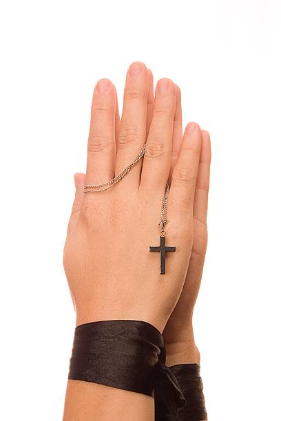 istock Woman is praying holding her cross. On white background. 178606395