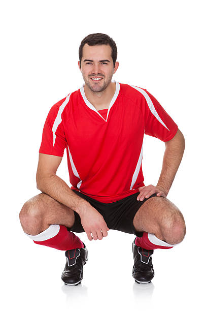 Portrait of professional soccer player Portrait of professional soccer player. Isolated on white standing had to knee pose stock pictures, royalty-free photos & images