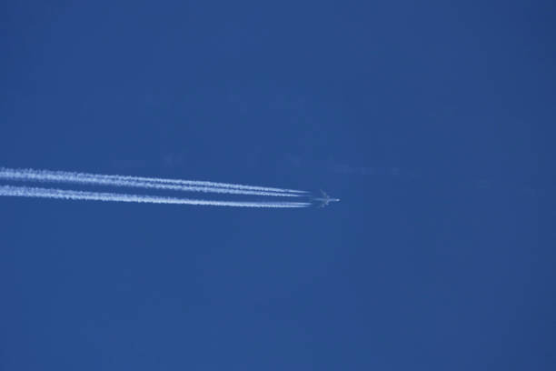 istock airplane in the blue sky, contrail 1786075719