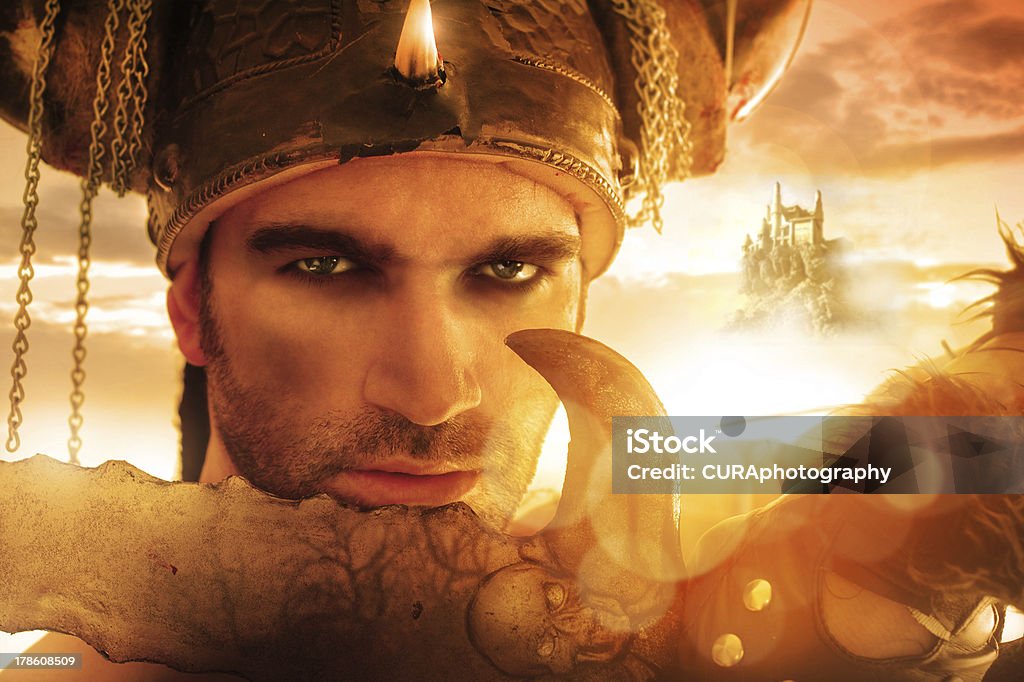 Warrior face Portrait of a seexy strong warrior holding sword in golden light with fantasy background Ethereal Stock Photo