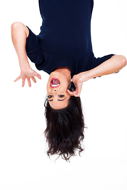 istock woman talking on cellphone upside down 178608654
