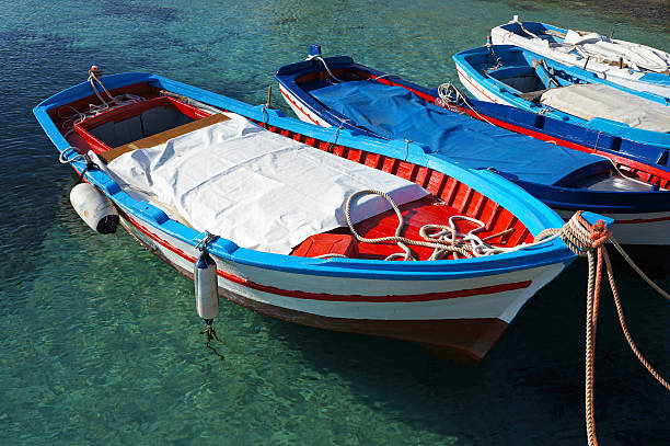Wooden fishing boats on crystalline water stock photo