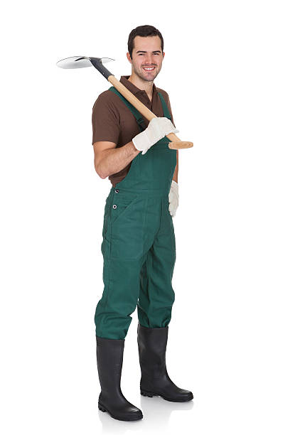 Happy young gardener in dungarees. Isolated on white