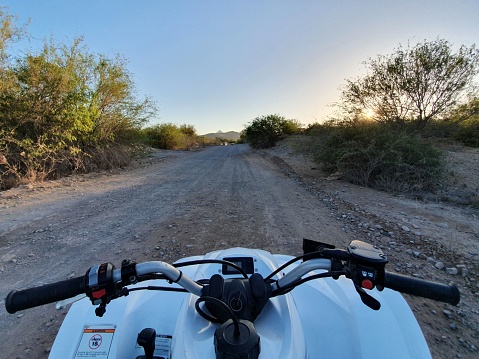Baja California, Mexico – May 10, 2019: View from a motorcycle of a dirt road in a wild, natural landscape
