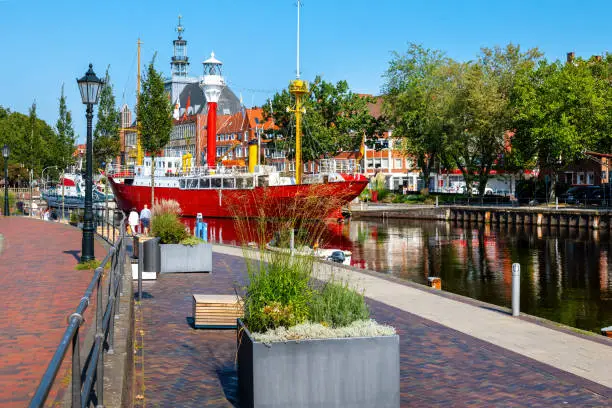 Harbor of Emden city with historic light vessel and sailship, Lower Saxony, Germany