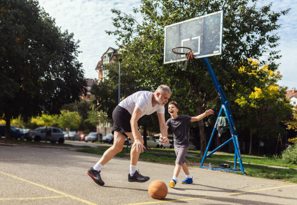 istock Mature man playing basketball with his son 1786108245