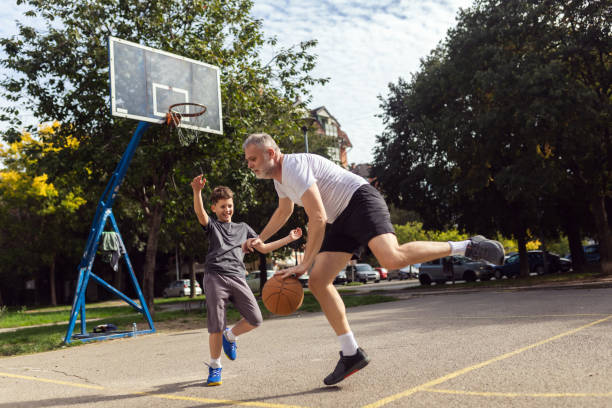 istock Mature man playing basketball with his son 1786108249