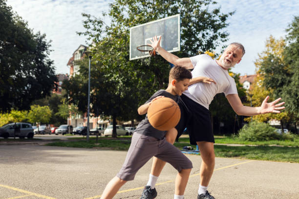 istock Mature man playing basketball with his son 1786108296