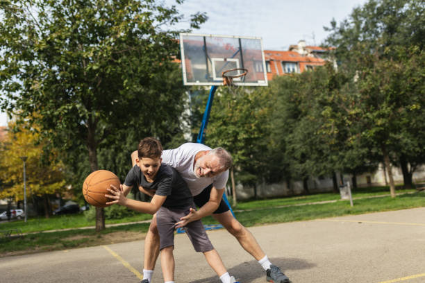 istock Mature man playing basketball with his son 1786108851