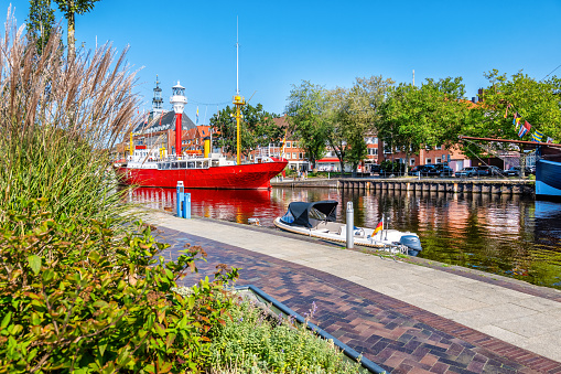 Harbor of Emden city with historic light vessel and sailship, Lower Saxony, Germany